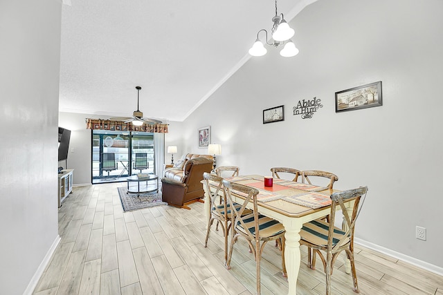 dining room featuring vaulted ceiling, light wood-style flooring, baseboards, ornamental molding, and a ceiling fan
