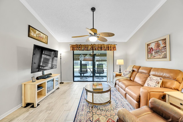 living area featuring crown molding, light wood-style flooring, a ceiling fan, baseboards, and a textured ceiling