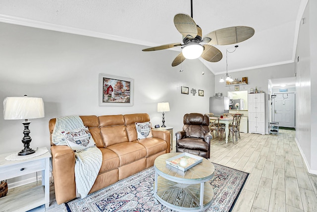 living area featuring ornamental molding, ceiling fan, lofted ceiling, light wood-style flooring, and baseboards