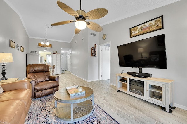 living area with ceiling fan, a chandelier, light wood-style floors, baseboards, and high vaulted ceiling