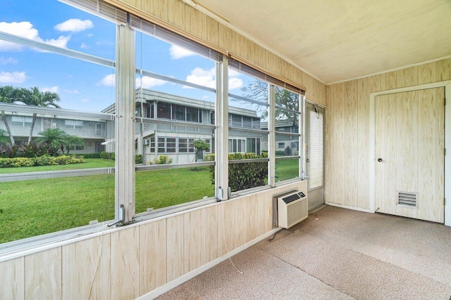unfurnished sunroom featuring a wall mounted AC