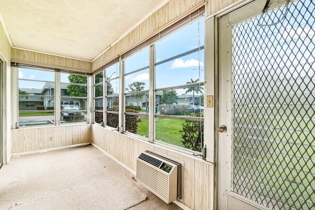 unfurnished sunroom featuring a wall mounted AC
