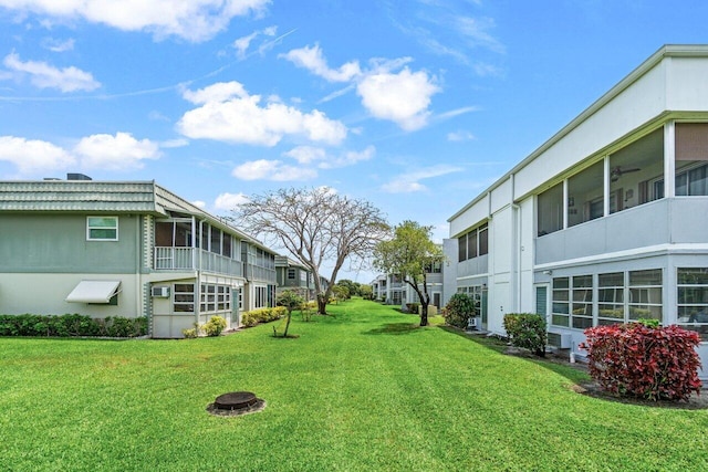 view of grassy yard with a residential view