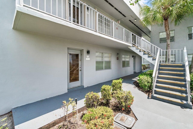 property entrance with stucco siding