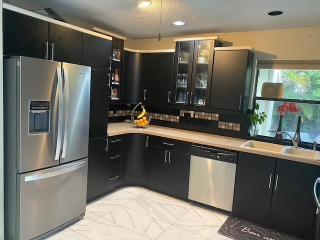 7514 Sierra Dr E, Boca Raton, FL 33433 - kitchen featuring appliances with stainless steel finishes, a sink, dark cabinets, a textured ceiling, and light countertops