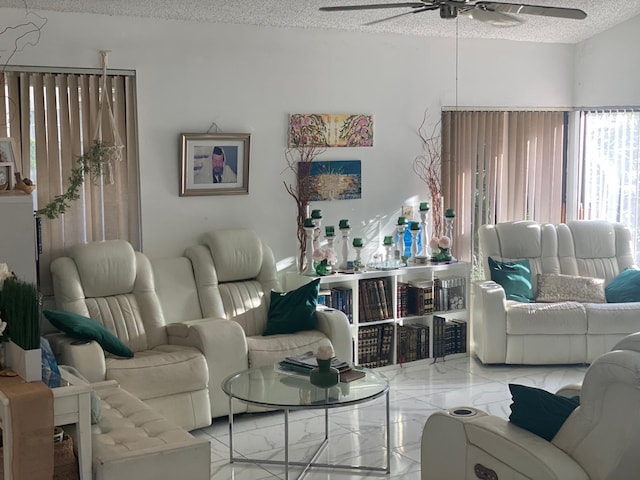 7514 Sierra Dr E, Boca Raton, FL 33433 - living room featuring marble tiled flooring, ceiling fan, and a textured ceiling