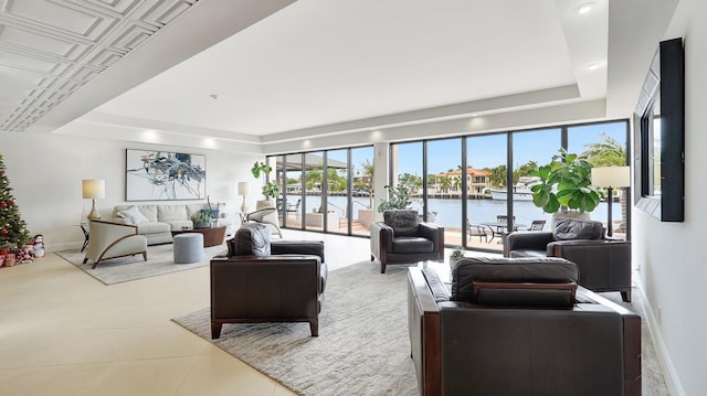 5100 Dupont Blvd Unit 7E, Fort Lauderdale, FL 33308 - living room featuring a tray ceiling, healthy amount of natural light, and a water view