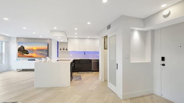 5100 Dupont Blvd Unit 7E, Fort Lauderdale, FL 33308 - kitchen featuring modern cabinets, white cabinets, light countertops, stainless steel dishwasher, and decorative backsplash