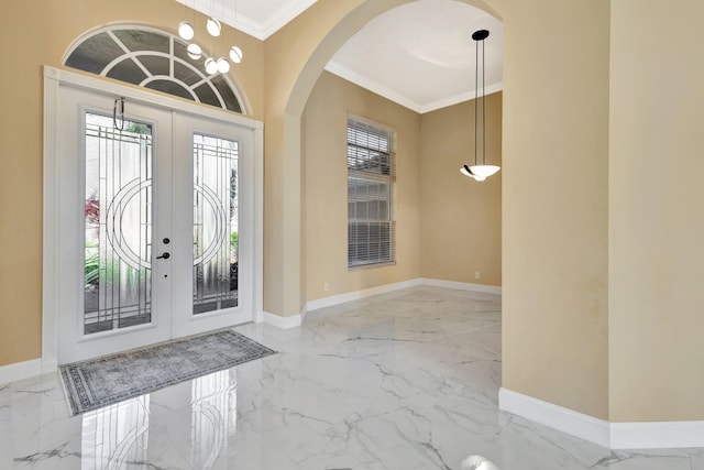 19236 Bay Leaf Ct, Boca Raton, FL 33498 - foyer with marble tiled floors, arched walkways, baseboards, and crown molding