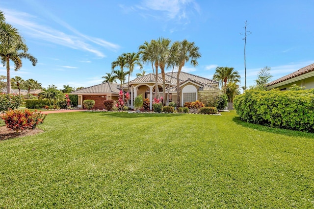 19236 Bay Leaf Ct, Boca Raton, FL 33498 - view of front of property with a front yard, stucco siding, and a tiled roof