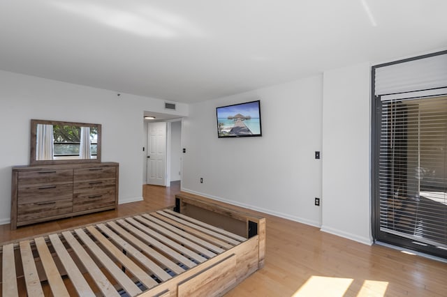 bedroom featuring wood finished floors and baseboards