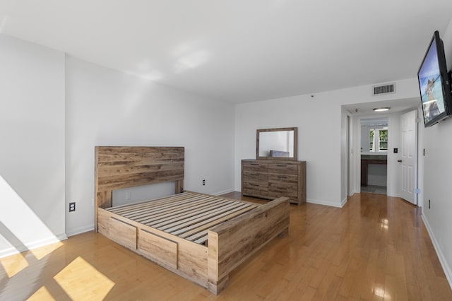 unfurnished bedroom featuring wood finished floors and baseboards