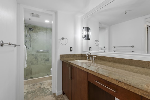 full bathroom with a shower stall, vanity, and toilet