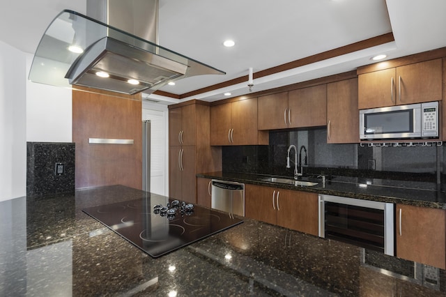 kitchen featuring a sink, wine cooler, appliances with stainless steel finishes, island exhaust hood, and backsplash