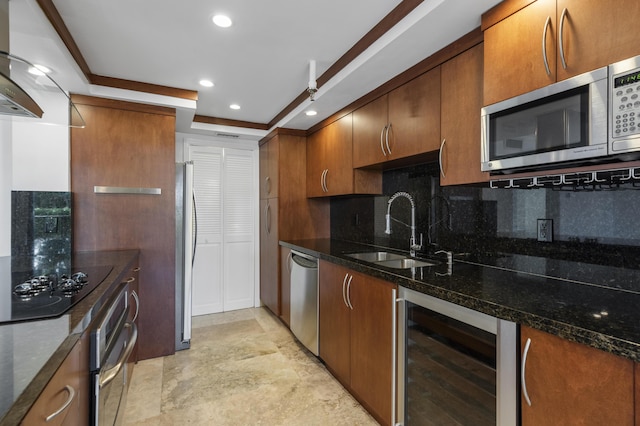 kitchen with wine cooler, a sink, appliances with stainless steel finishes, decorative backsplash, and dark stone counters