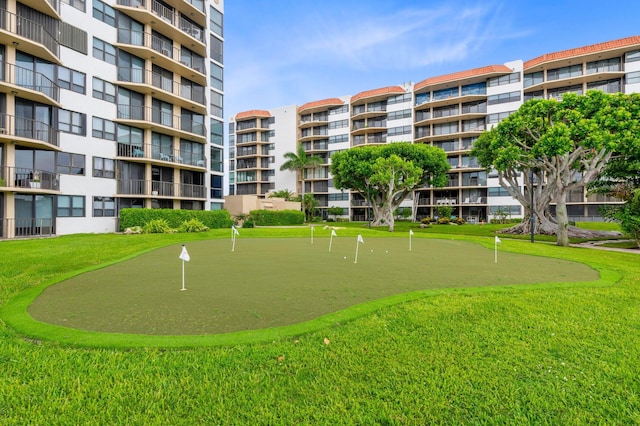 surrounding community with a putting area and a lawn