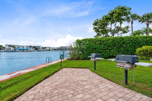 view of patio featuring a grill and a water view
