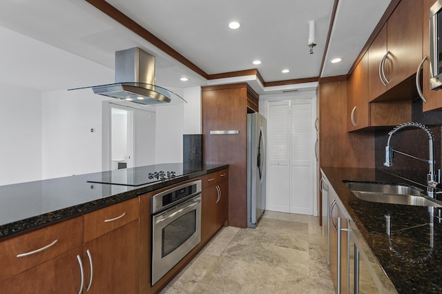 kitchen with appliances with stainless steel finishes, a sink, range hood, dark stone countertops, and tasteful backsplash
