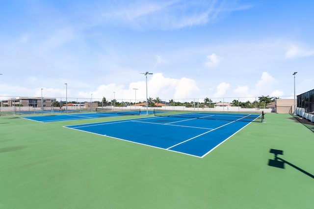 view of tennis court with fence