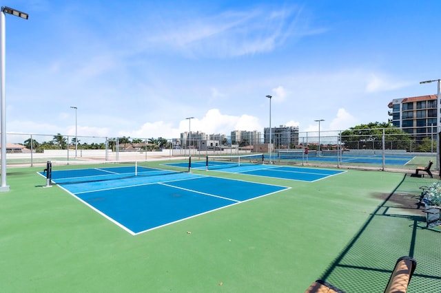view of tennis court featuring fence