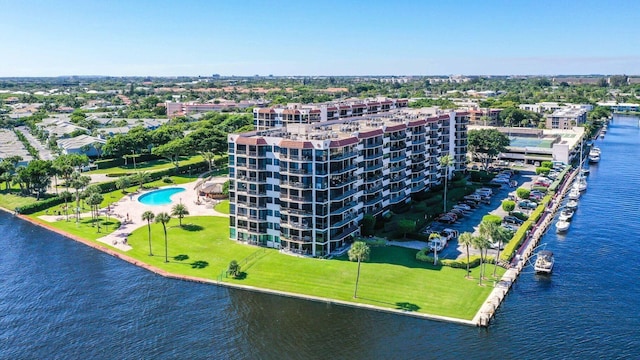 aerial view of apartment complex / building, a nearby body of water, and a pool