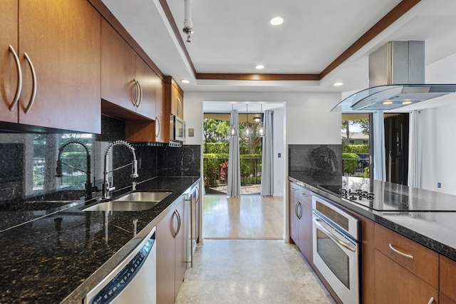 kitchen with appliances with stainless steel finishes, a sink, healthy amount of natural light, island range hood, and recessed lighting