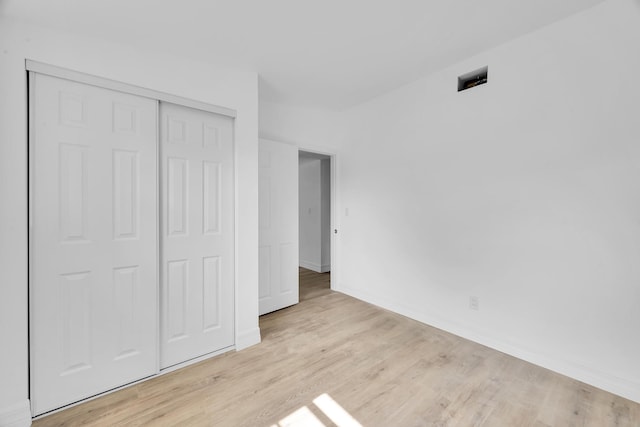907 Skylark Dr, Fort Pierce, FL 34982 - unfurnished bedroom featuring light wood-style flooring, a closet, and baseboards