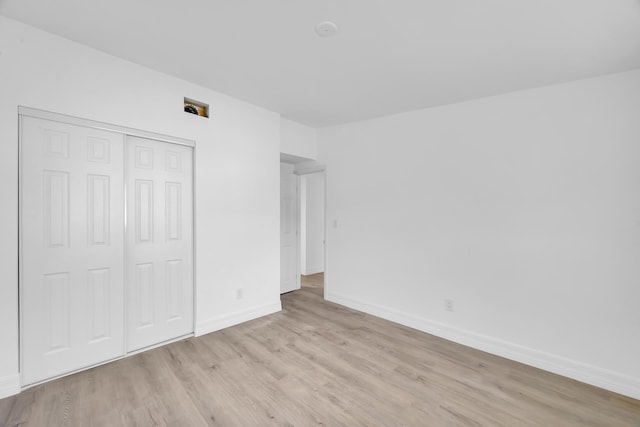 907 Skylark Dr, Fort Pierce, FL 34982 - unfurnished bedroom featuring wood finished floors, a closet, and baseboards
