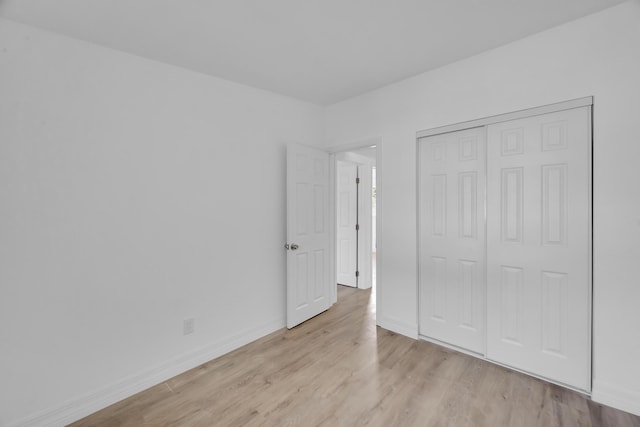 907 Skylark Dr, Fort Pierce, FL 34982 - unfurnished bedroom with light wood-style flooring, baseboards, and a closet