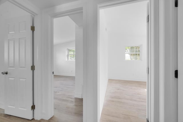 907 Skylark Dr, Fort Pierce, FL 34982 - hall featuring light wood finished floors, baseboards, and lofted ceiling