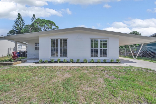 907 Skylark Dr, Fort Pierce, FL 34982 - view of property exterior featuring a carport and concrete driveway