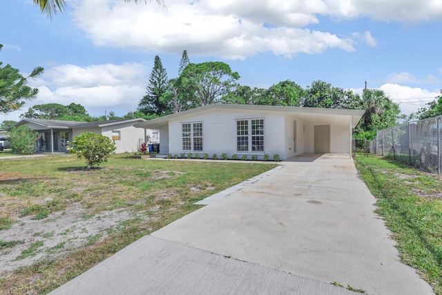 907 Skylark Dr, Fort Pierce, FL 34982 - single story home with concrete driveway, an attached carport, and stucco siding