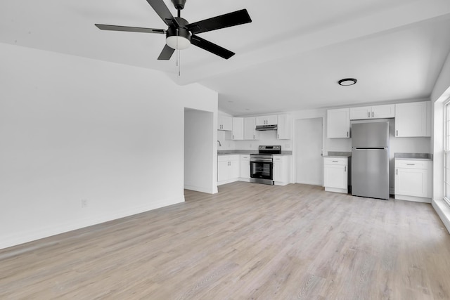 907 Skylark Dr, Fort Pierce, FL 34982 - unfurnished living room with vaulted ceiling, ceiling fan, light wood-style floors, baseboards, and a sink