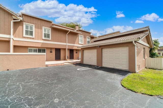 4341 Coral Springs Dr Unit 1G, Coral Springs, FL 33065 - multi unit property with asphalt driveway, a garage, and stucco siding