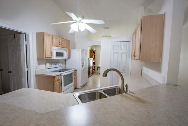 kitchen featuring white appliances, a sink, arched walkways, ceiling fan, and high vaulted ceiling