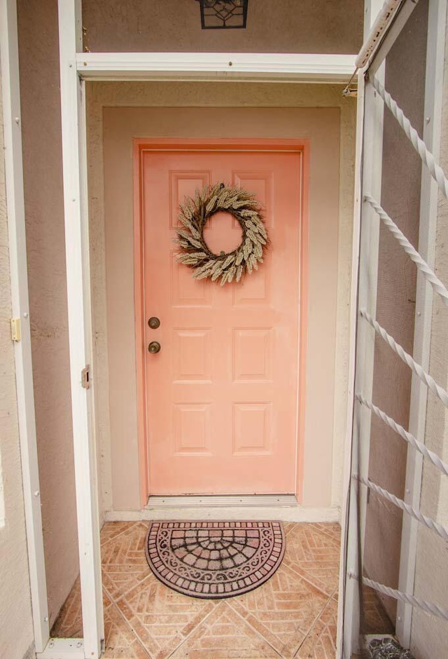 entrance to property with stucco siding