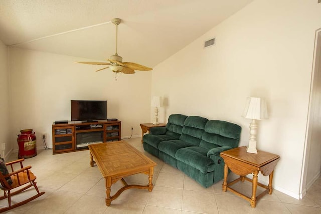 living room with vaulted ceiling, a ceiling fan, light tile patterned flooring, and baseboards