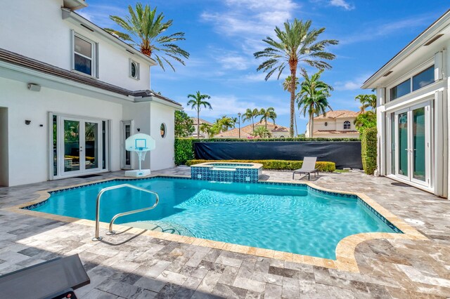 view of pool featuring french doors, a patio, and a pool with connected hot tub