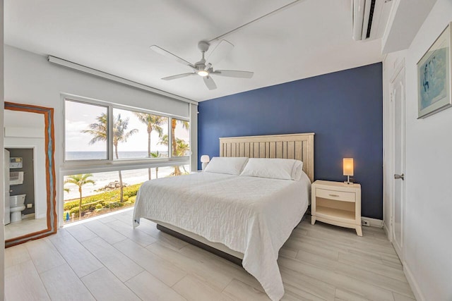 bedroom featuring baseboards, ceiling fan, and light wood-style flooring