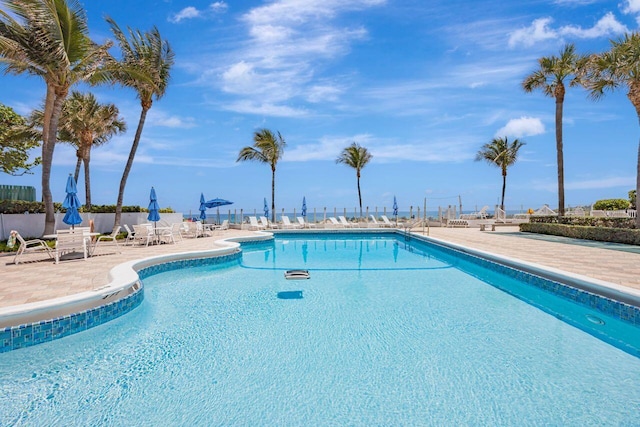 community pool featuring a patio area and fence