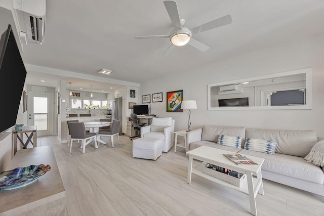 living room featuring a ceiling fan and light wood-style flooring