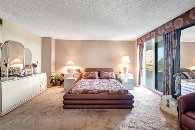 bedroom featuring access to outside, carpet floors, and a textured ceiling