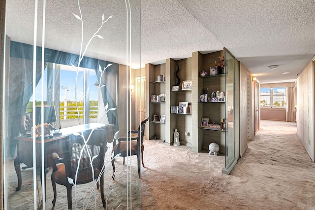 dining space with a textured ceiling and carpet flooring