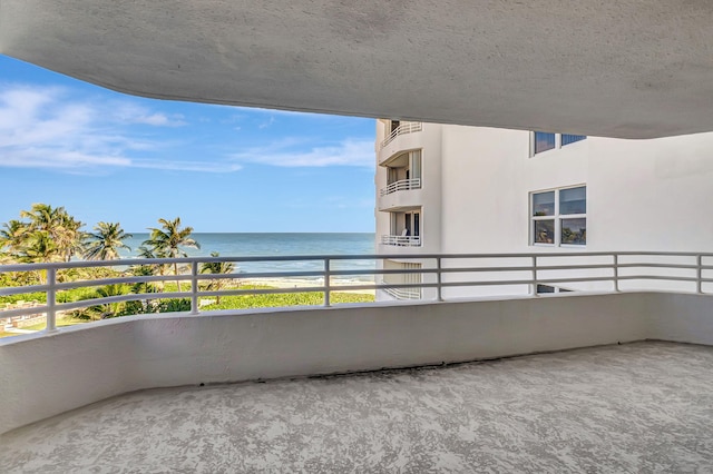 balcony with view of water and beach