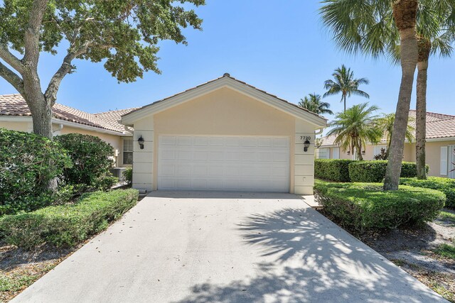 single story home with concrete driveway, stucco siding, and a garage