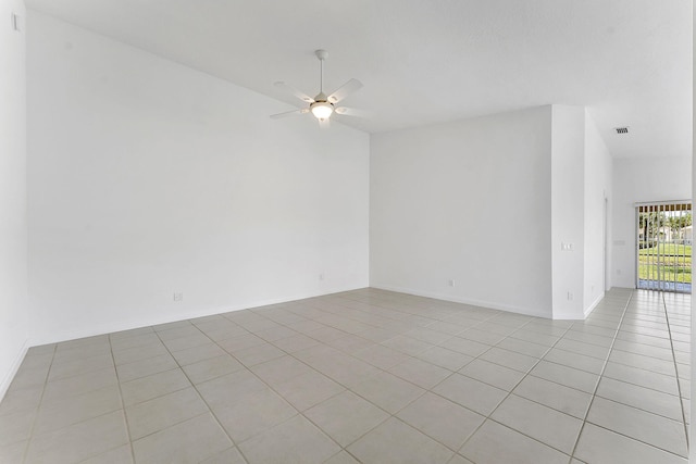 spare room featuring ceiling fan and light tile patterned floors