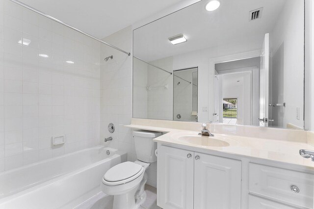 full bathroom with toilet, vanity, and  shower combination