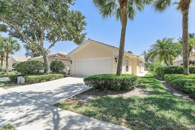 mediterranean / spanish-style house with a tile roof, stucco siding, a garage, and driveway
