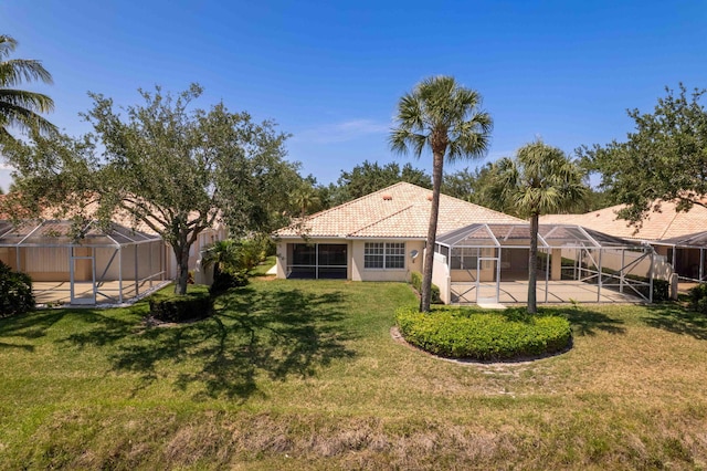 7720 Pine Island Way, West Palm Beach, FL 33411 - back of house featuring a lanai, a yard, a patio area, stucco siding, and a tile roof