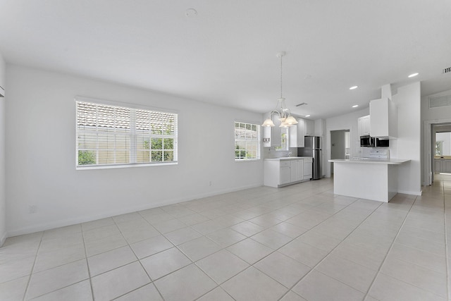 unfurnished living room featuring a chandelier, baseboards, light tile patterned flooring, and recessed lighting